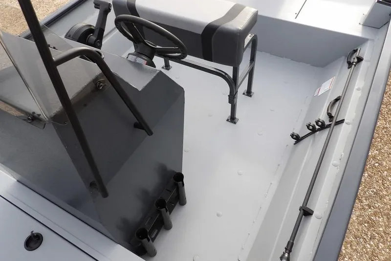 Slide: The Image of 2026 Crestliner 1870 Retriever FCC interior with steering console and seating. - 25