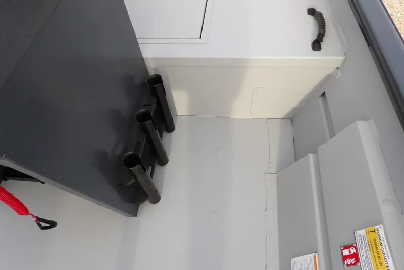 Slide: The Image of Interior of 2026 Crestliner 1870 Retriever FCC boat with rod holders and storage compartment. - 26