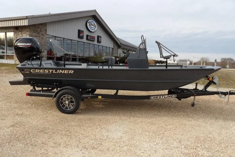 Slide: The Image of 2026 Crestliner 1870 Retriever FCC boat on trailer, parked outside dealership. - 3