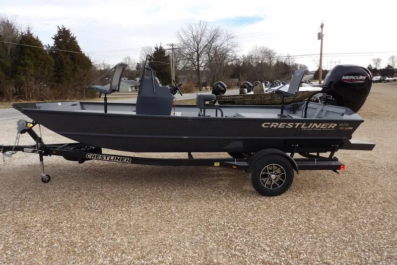 Slide: The Image of 2026 Crestliner 1870 Retriever FCC boat on trailer, side view, outdoors. - 8