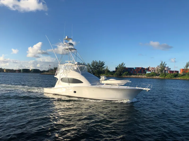 Slide: The Image of 2006 Hatteras 64 Convertible yacht cruising on a sunny day. - 1