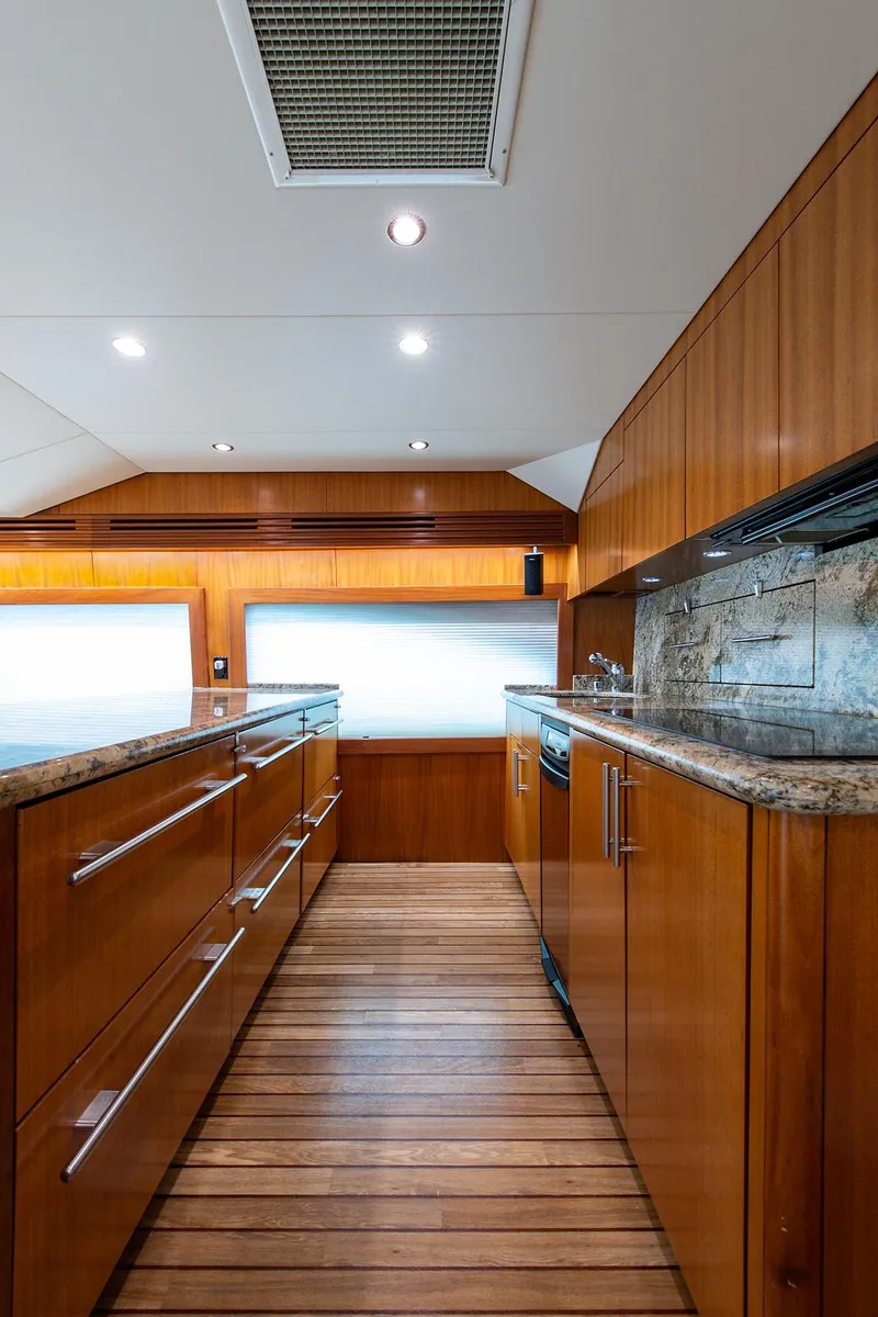 Slide: The Image of Interior of 2006 Hatteras 64 Convertible yacht with wooden cabinetry and flooring. - 15