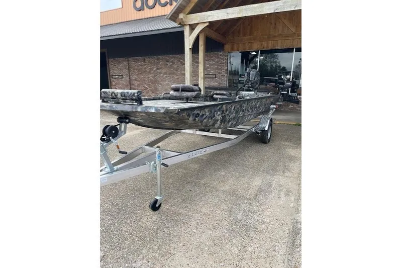 Slide: The Image of 2026 Excel Eclipse Jet boat on trailer outside building. - 2