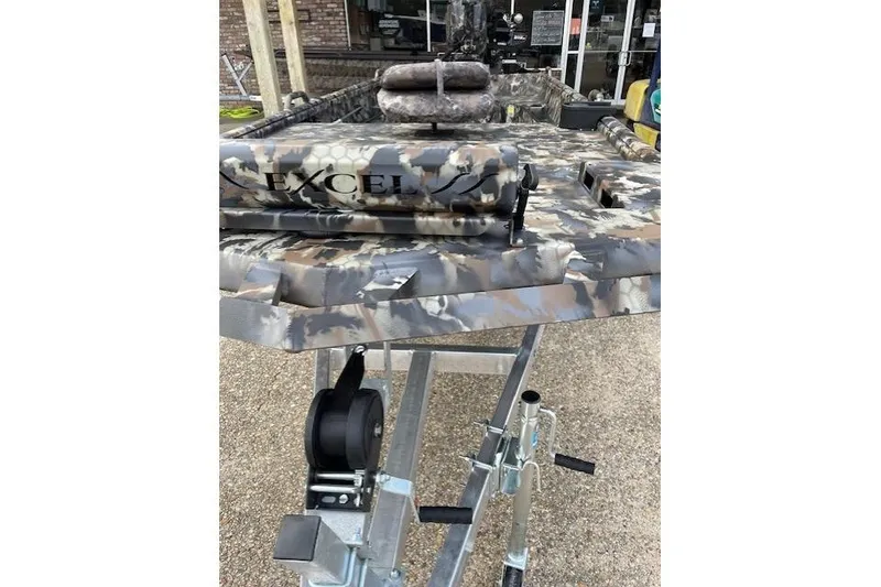 Slide: The Image of 2026 Excel Eclipse Jet boat with camouflage pattern on trailer. - 4