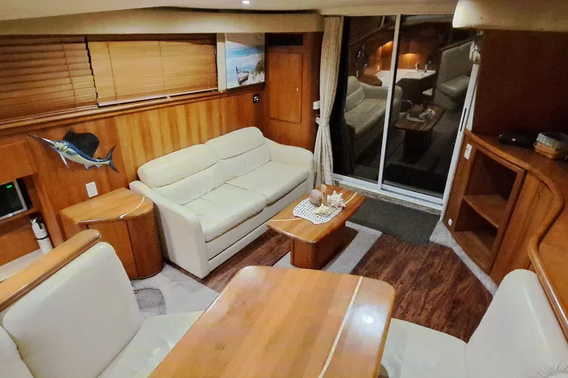 Slide: The Image of Interior of 2000 Silverton 42 Convertible yacht with elegant wood and leather furnishings. - 11