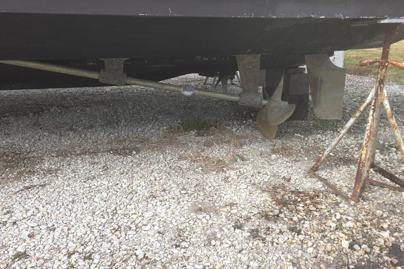 Slide: The Image of Bottom view of a 2000 Silverton 42 Convertible boat on gravel. - 19