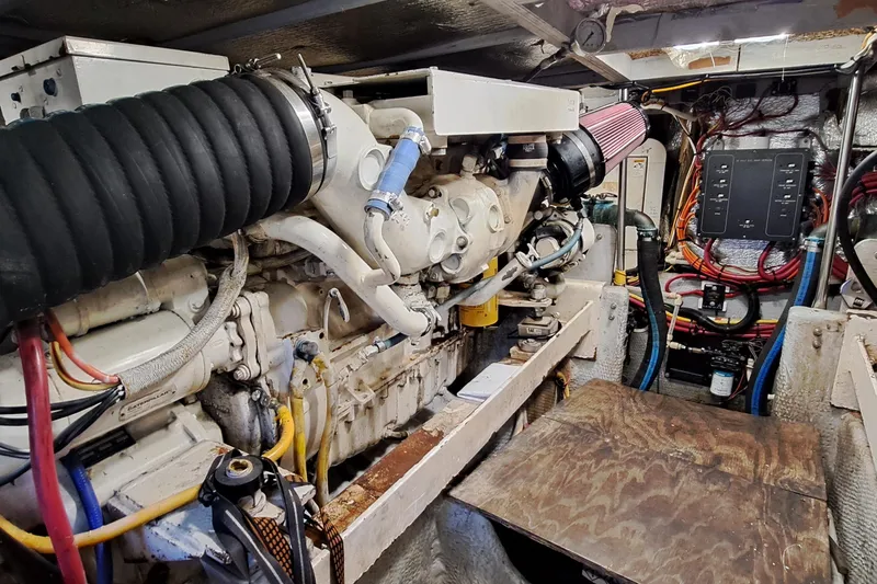 Slide: The Image of Engine room of a 2000 Silverton 42 Convertible yacht, showcasing complex machinery and wiring. - 21