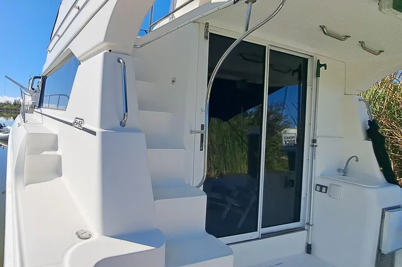 Slide: The Image of 2000 Silverton 42 Convertible yacht with sliding glass doors and outdoor sink. - 4
