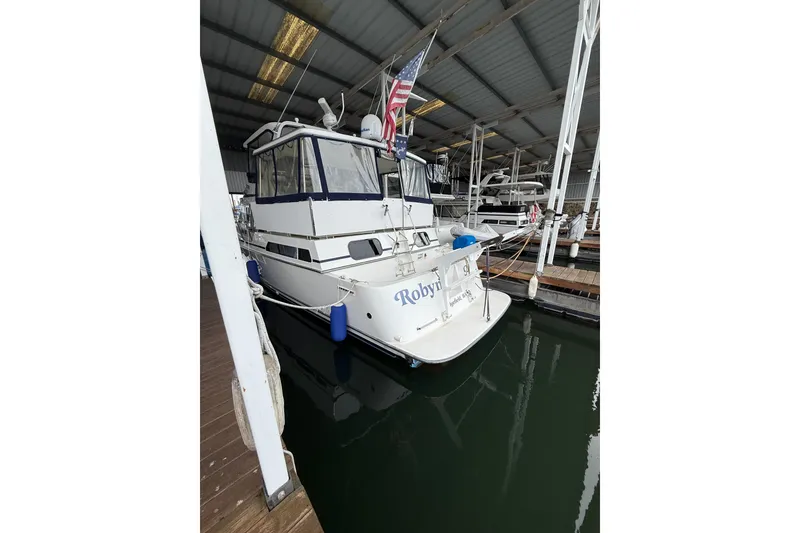 Slide: The Image of 1994 Tollycraft 45 Cockpit Motor Yacht docked in a marina. - 11