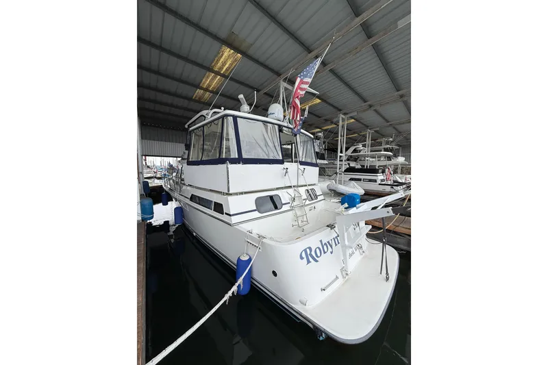 Slide: The Image of 1994 Tollycraft 45 Cockpit Motor Yacht docked in a covered marina. - 13