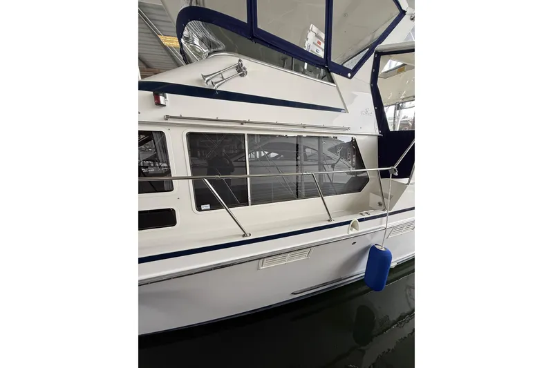 Slide: The Image of 1994 Tollycraft 45 Cockpit Motor Yacht side view with blue fender in marina. - 14