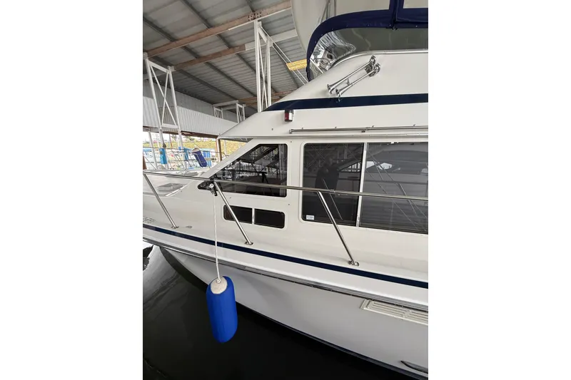 Slide: The Image of 1994 Tollycraft 45 Cockpit Motor Yacht docked in a covered marina. - 15