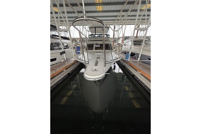 Slide: The Image of 1994 Tollycraft 45 Cockpit Motor Yacht docked in a marina. - 16