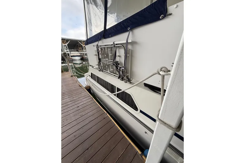 Slide: The Image of Side view of 1994 Tollycraft 45 Cockpit Motor Yacht docked at marina. - 20