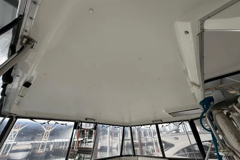 Slide: The Image of Interior view of 1994 Tollycraft 45 Cockpit Motor Yacht with marina background. - 23