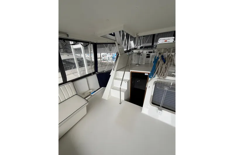 Slide: The Image of 1994 Tollycraft 45 Cockpit Motor Yacht interior with seating and stairs. - 25