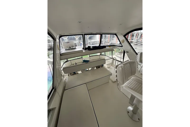 Slide: The Image of 1994 Tollycraft 45 Cockpit Motor Yacht interior with seating and helm station. - 31