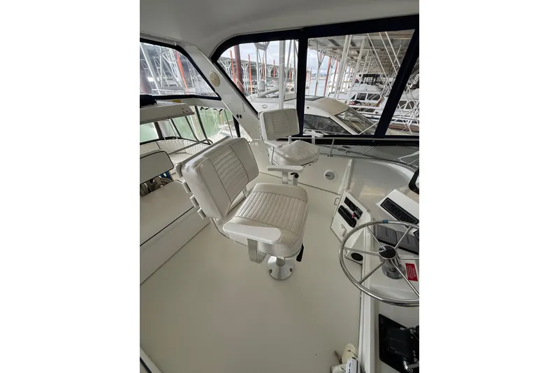 Slide: The Image of 1994 Tollycraft 45 Cockpit Motor Yacht interior with helm and seating area. - 32