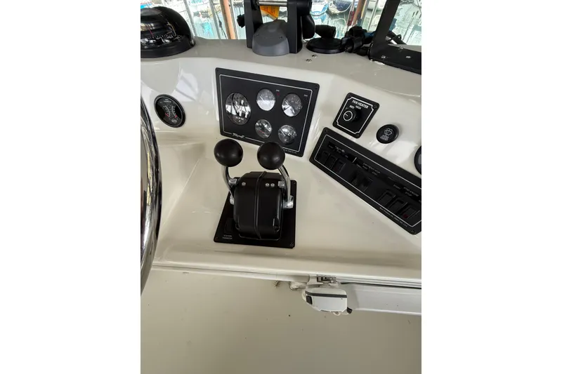 Slide: The Image of Control panel of 1994 Tollycraft 45 Cockpit Motor Yacht with gauges and levers. - 34