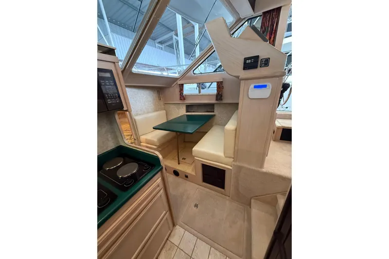 Slide: The Image of 1994 Tollycraft 45 Cockpit Motor Yacht interior with dining area and kitchen. - 40