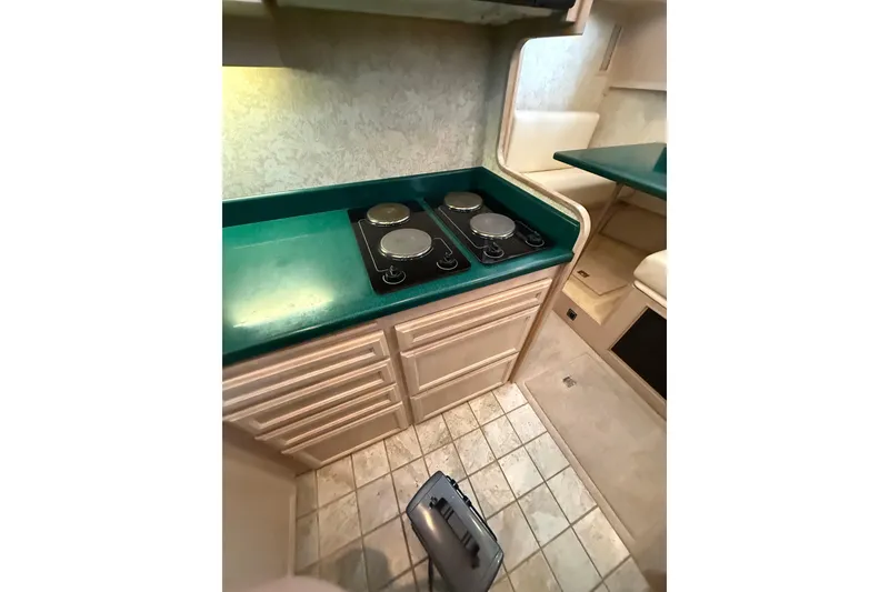 Slide: The Image of 1994 Tollycraft 45 Cockpit Motor Yacht kitchen with green countertop and electric stove. - 41