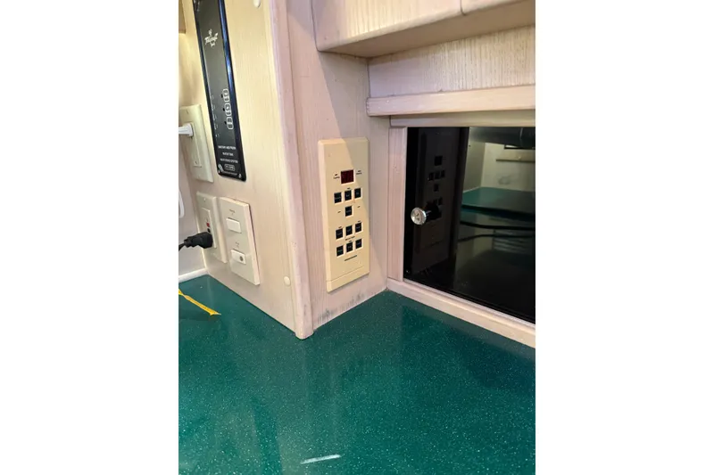 Slide: The Image of 1994 Tollycraft 45 Cockpit Motor Yacht interior with control panel and outlets. - 44