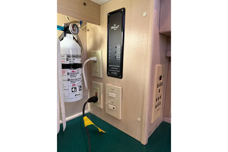 Slide: The Image of 1994 Tollycraft 45 Cockpit Motor Yacht interior with control panel and fire extinguisher. - 45