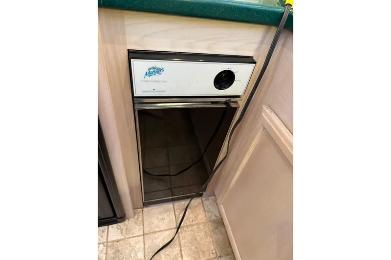 Slide: The Image of Trash compactor in 1994 Tollycraft 45 Cockpit Motor Yacht kitchen area. - 48