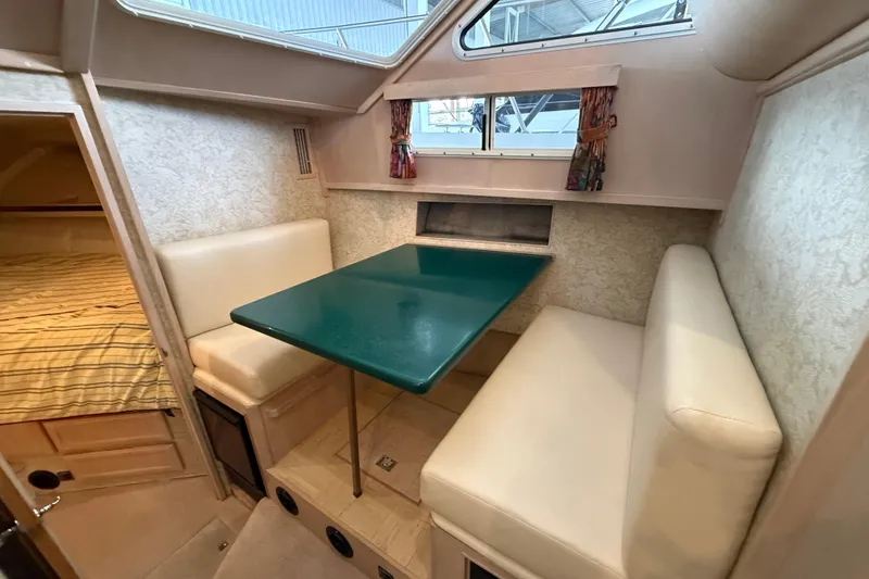 Slide: The Image of 1994 Tollycraft 45 Cockpit Motor Yacht interior with dining area and cozy seating. - 50