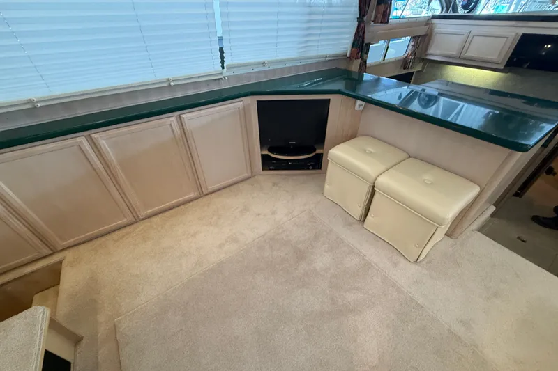 Slide: The Image of 1994 Tollycraft 45 Cockpit Motor Yacht interior with beige cabinets and green countertop. - 56