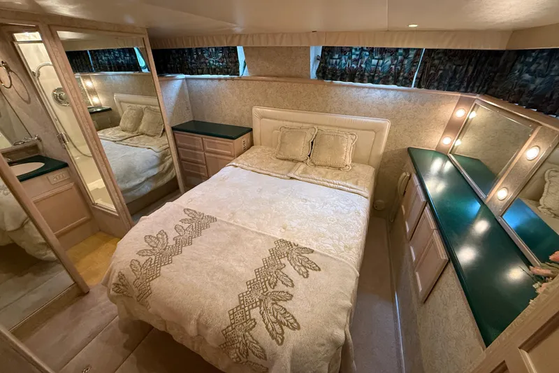 Slide: The Image of Luxurious bedroom in 1994 Tollycraft 45 Cockpit Motor Yacht with elegant decor and ample lighting. - 59