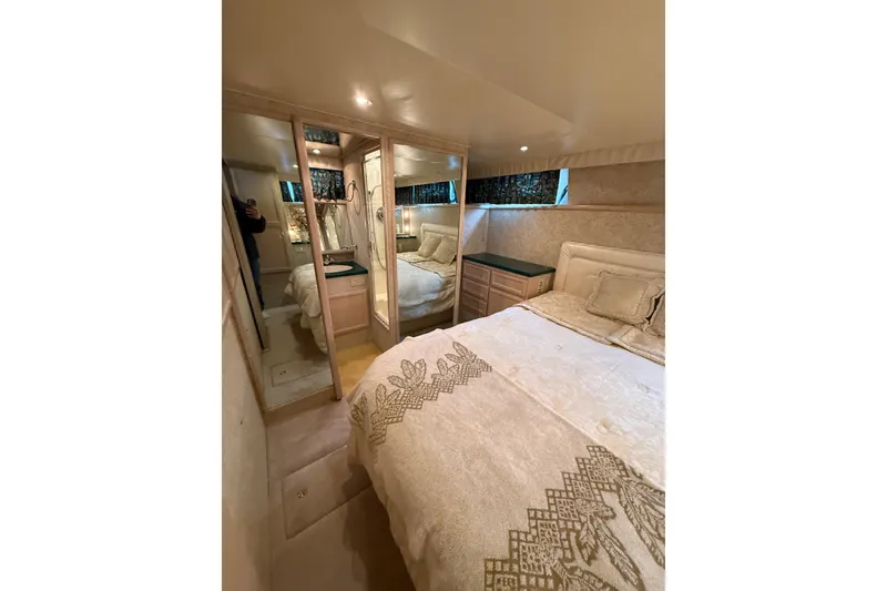 Slide: The Image of Luxurious bedroom interior of 1994 Tollycraft 45 Cockpit Motor Yacht with elegant decor. - 62