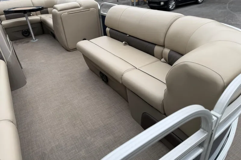 Slide: The Image of 2020 Sun Tracker Party Barge 20 DLX interior with beige seating and table. - 4