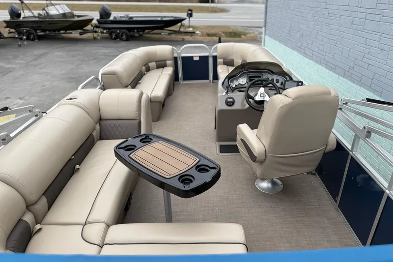 Slide: The Image of 2020 Sun Tracker Party Barge 20 DLX with beige seating and steering console. - 9