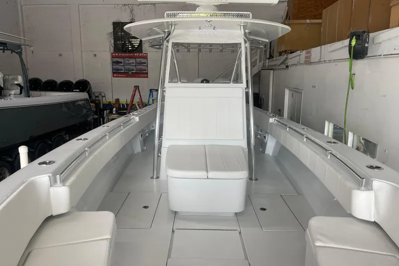 Slide: The Image of 2024 Contender 39 ST boat interior with seating and equipment in a garage setting. - 13