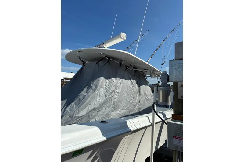 Slide: The Image of 2024 Contender 39 ST boat with Yamaha XTO outboard engines docked by waterfront. - 18