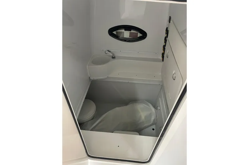 Slide: The Image of 2024 Contender 39 ST boat dashboard with Garmin controls and cup holders. - 21