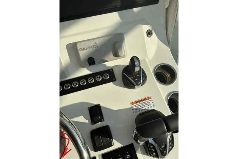 Slide: The Image of 2024 Contender 39 ST boat console with Garmin navigation displays and steering wheel. - 22