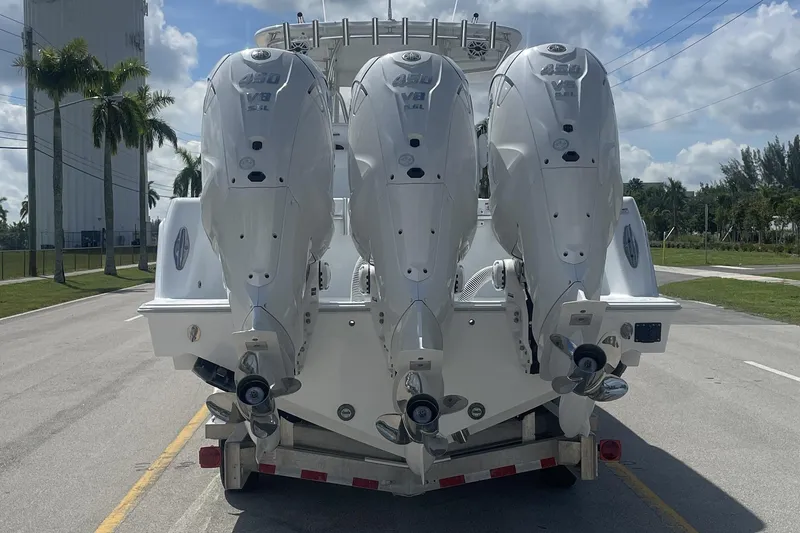 Slide: The Image of 2024 Contender 39 ST boat interior with seating and speakers, docked by a canal. - 6