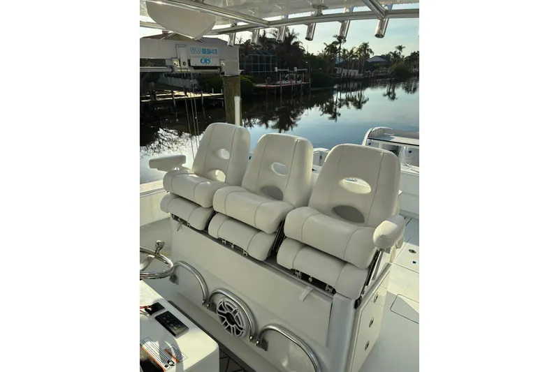 Slide: The Image of 2024 Contender 39 ST boat seating area with rod holders and white upholstery. - 8