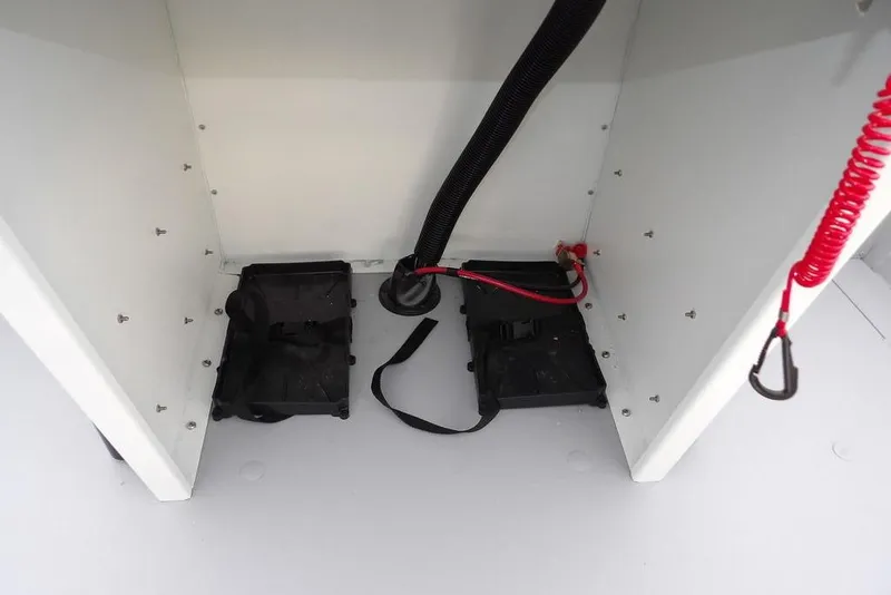 Slide: The Image of Interior view of 2026 Crestliner 1870 Retriever FCC boat compartment with wiring and battery holders. - 21