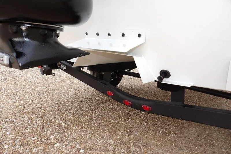 Slide: The Image of 2026 Crestliner 1870 Retriever FCC boat trailer detail with red lights and black components. - 31