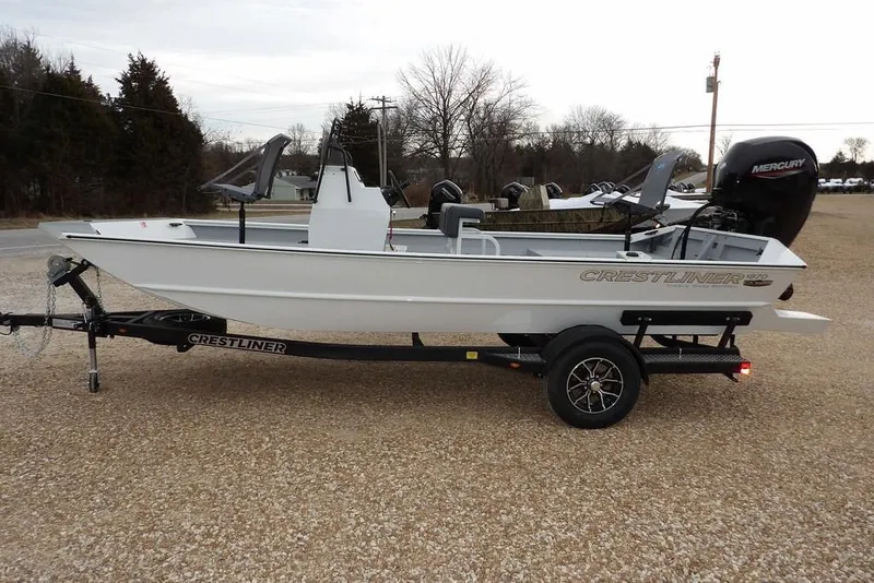 Slide: The Image of 2026 Crestliner 1870 Retriever FCC boat on trailer, side view, outdoors. - 5