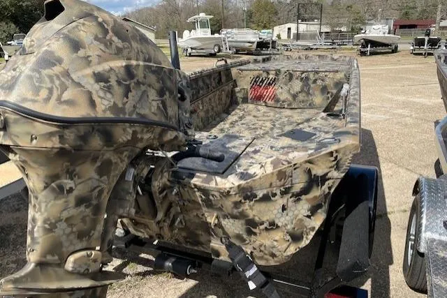 Slide: The Image of Camouflage-patterned 2026 Excel Eclipse 1554 boat on trailer, parked outdoors. - 4