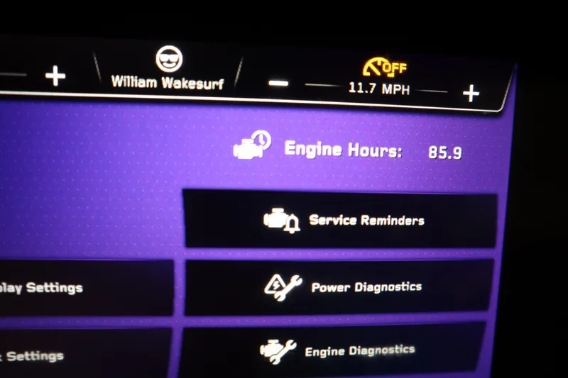 Slide: The Image of 2023 Nautique Super Air Nautique G23 dashboard displaying engine hours and diagnostics options. - 12