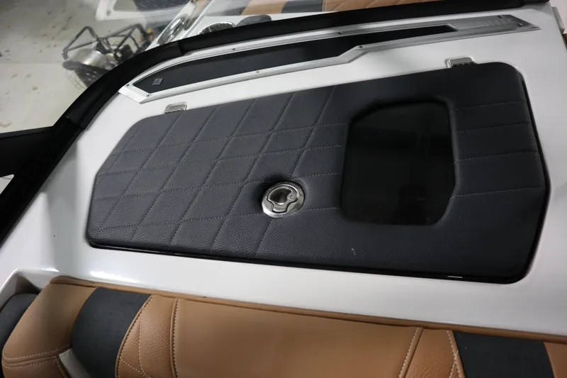 Slide: The Image of 2023 Nautique Super Air Nautique G23 interior detail with black and tan upholstery. - 14