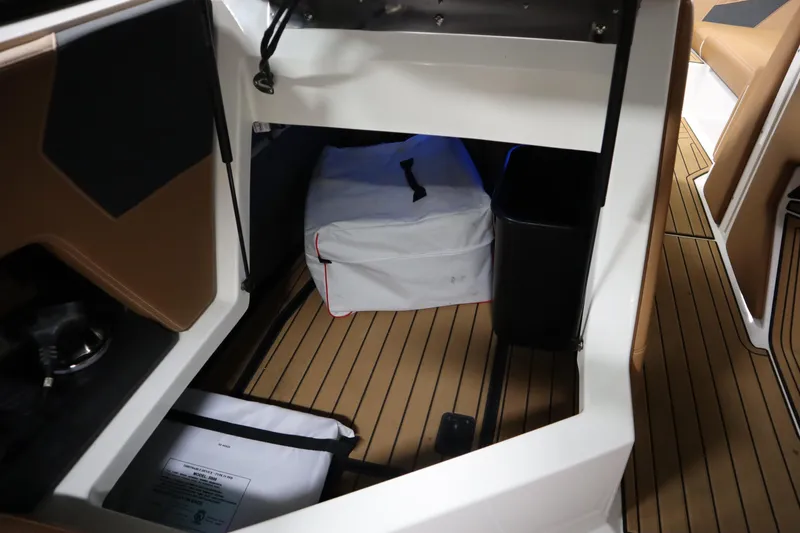 Slide: The Image of 2023 Nautique Super Air Nautique G23 interior storage area with brown flooring. - 17