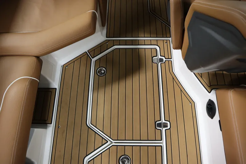 Slide: The Image of 2023 Nautique Super Air Nautique G23 interior with tan seating and teak-style flooring. - 18