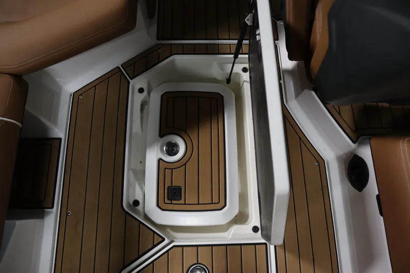 Slide: The Image of 2023 Nautique Super Air Nautique G23 interior storage compartment with teak flooring. - 19