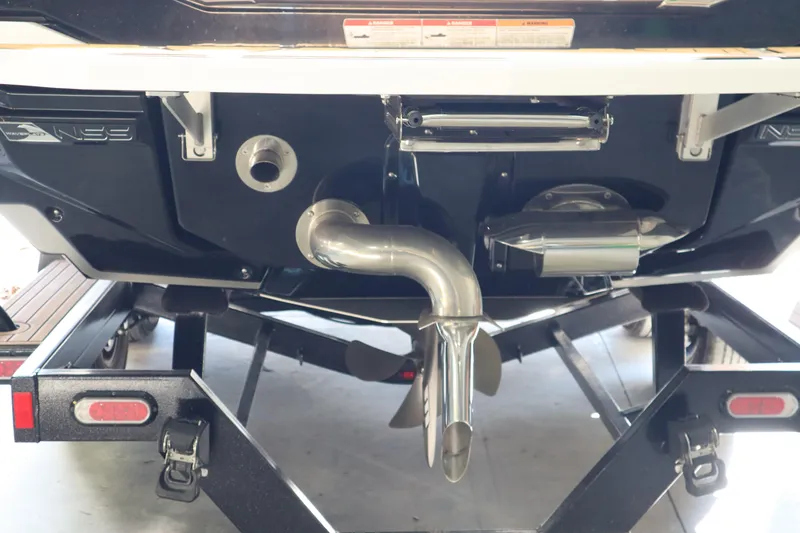 Slide: The Image of 2023 Nautique Super Air Nautique G23 boat stern with exhaust and propeller details. - 2